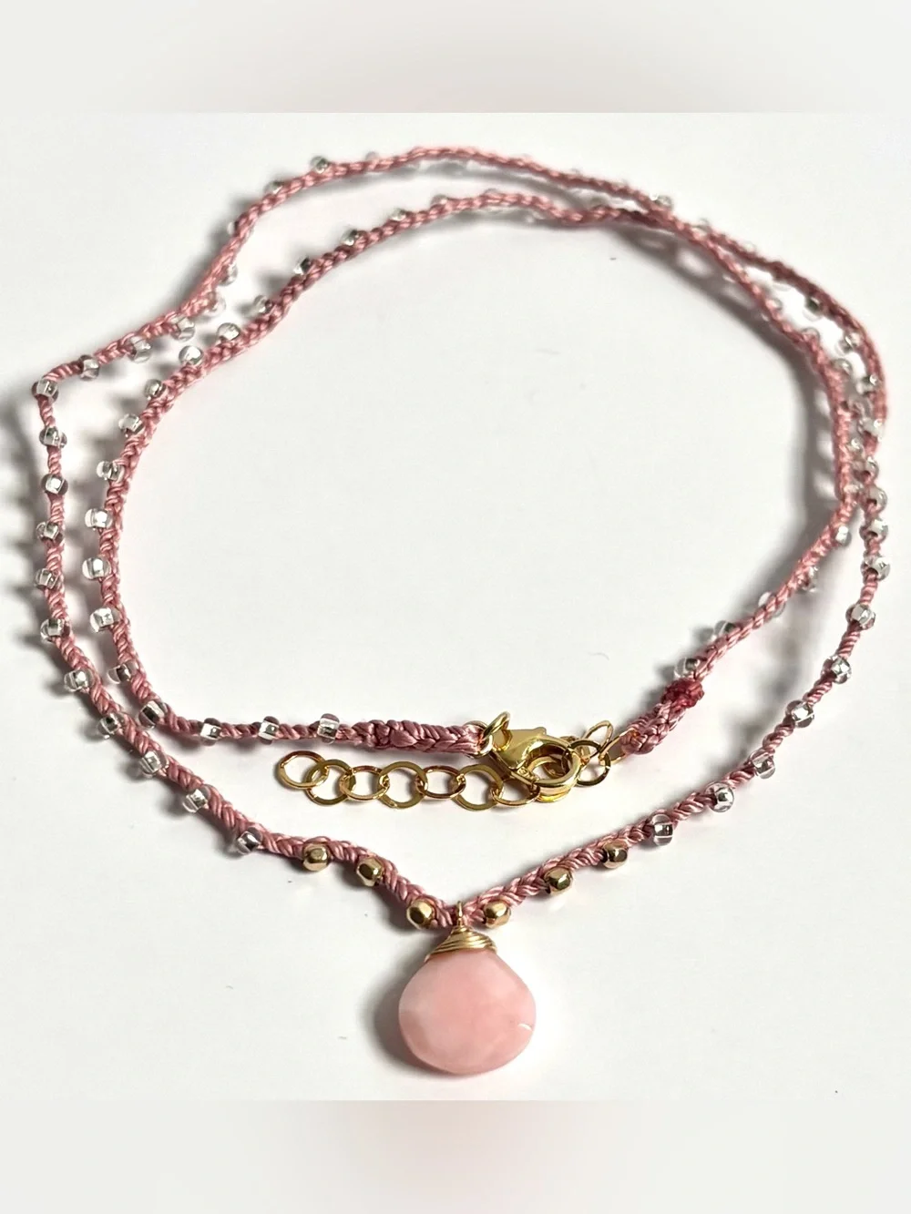 Pink silk thread necklace with a beautiful pink coral briolette stone